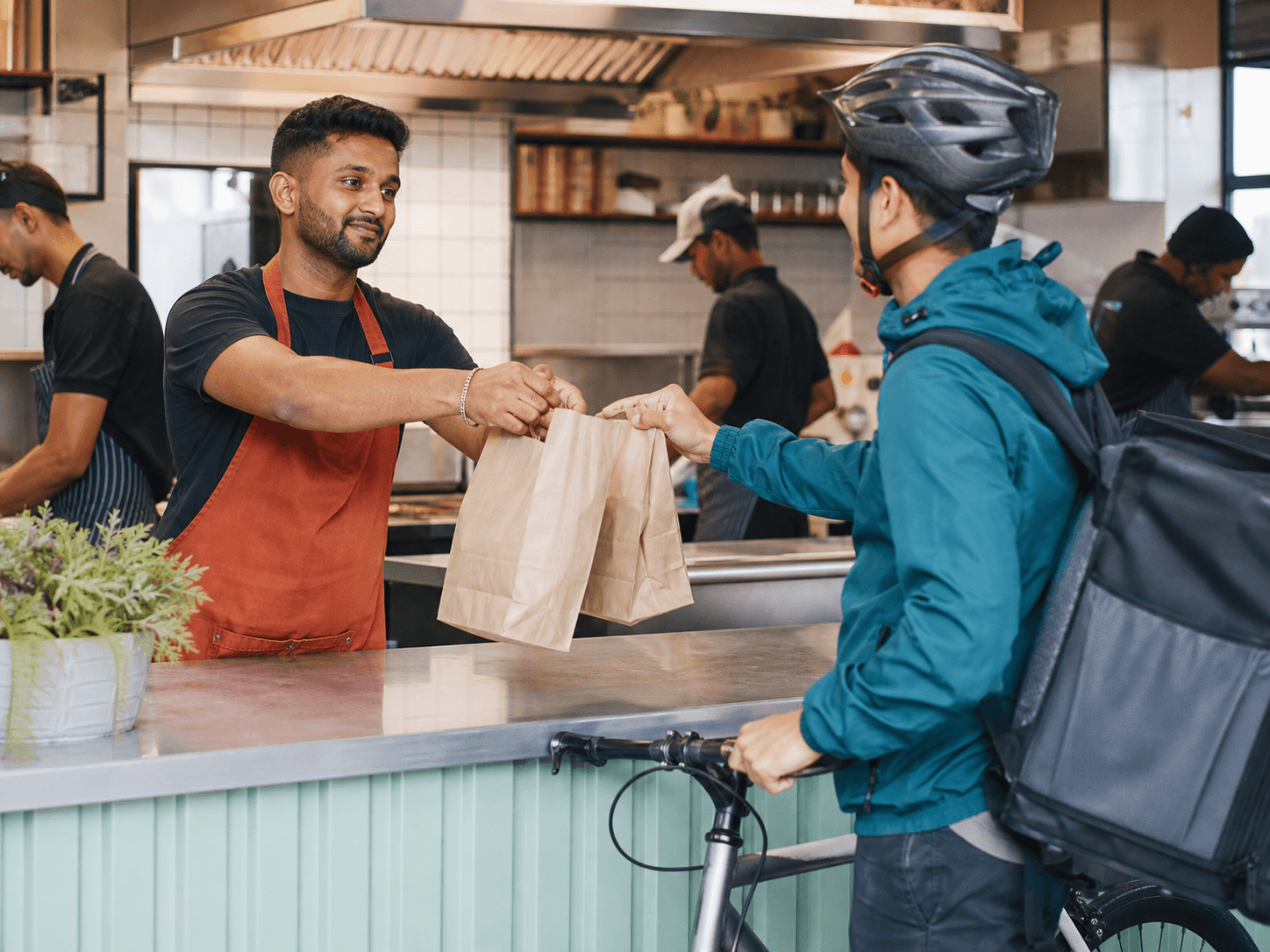 Customer ordering at a busy takeaway counter